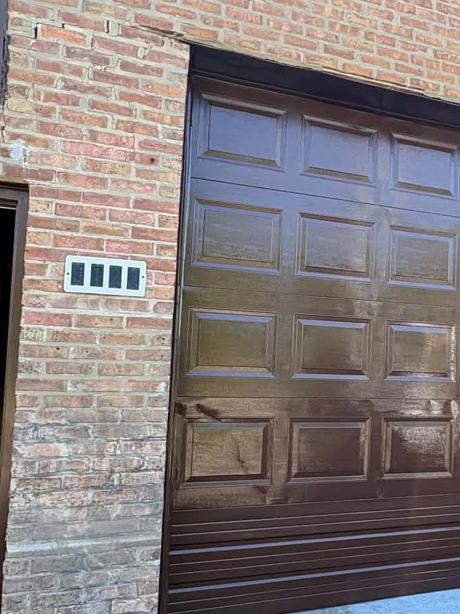 After: garage door with a fresh, even spray-applied finish