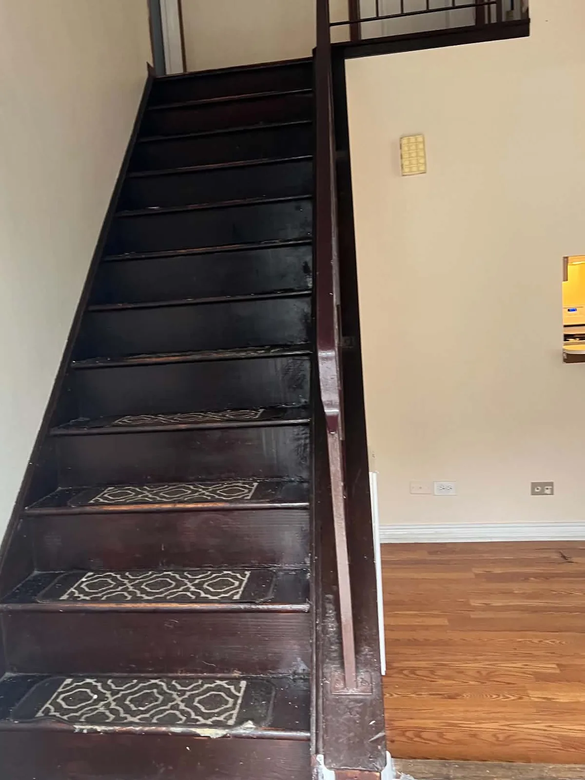 Before: dark, worn staircase with loose runners